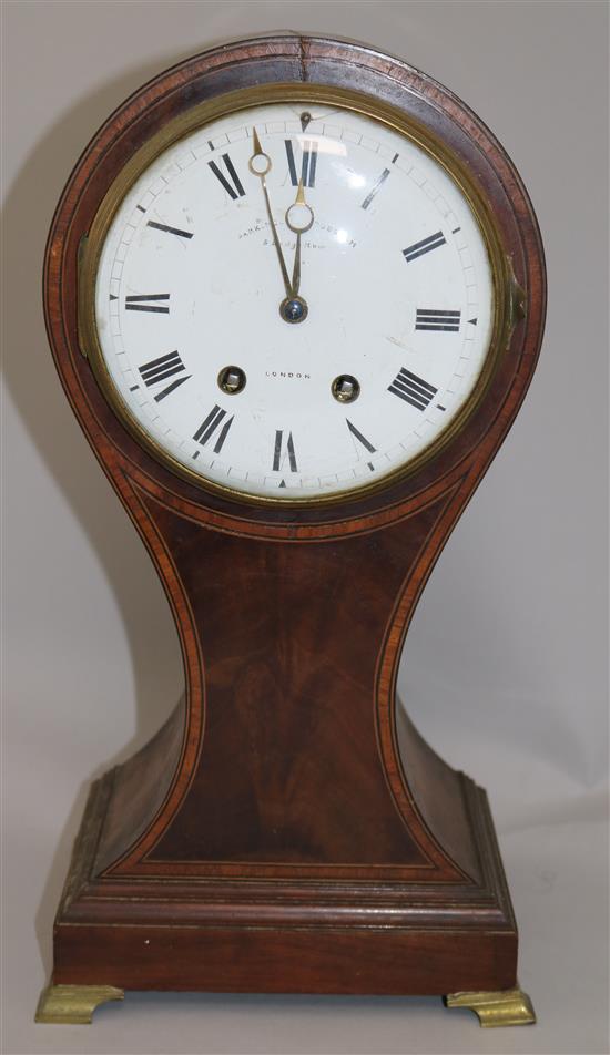 An Edwardian cross banded mahogany balloon cased mantel clock, 15in.